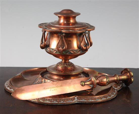 A Victorian gothic revival coppered brass inkwell and matching paperknife, inkwell diam. 8in.